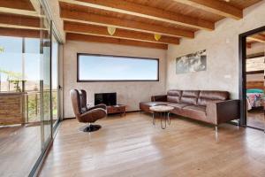 a living room with a couch and a chair at Tayu Eco Villa in Villaverde
