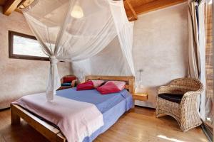 a bedroom with a bed and two chairs in it at Tayu Eco Villa in Villaverde +20 photos