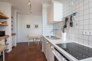 a kitchen with a sink and a table in it at Villa Bianca in Toscolano Maderno
