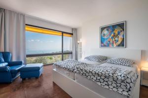 a bedroom with a bed and a large window at Villa Bianca in Toscolano Maderno +18 photos