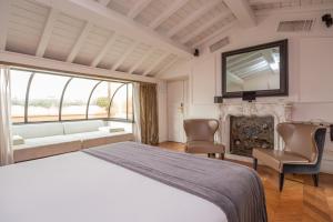 a bedroom with a large bed and a fireplace at Hotel The Corner Roma in Rome +44 photos