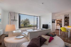 a living room with a couch and a large window at Villa Bianca in Toscolano Maderno