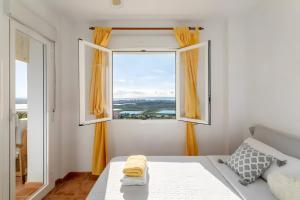 a bedroom with a window with orange curtains at Appartement avec 2 piscines in Mutxamel +18 photos