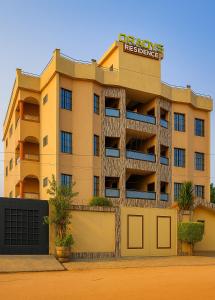 a building with a sign on top of it at ORADYS Residence in Sanguéra
