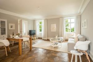 a living room with a couch and a table at Schloss Kirchberg - Rose in Immenstaad am Bodensee