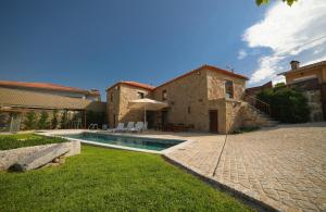a house with a swimming pool in a yard at Villae Carreiro in Palmeira