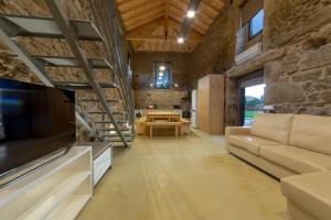 a living room with a couch and a table at Villae Carreiro in Palmeira