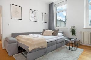 a living room with a couch and a table at Zeitlos Zuhause Bregenz in Bregenz