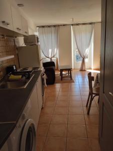 a kitchen with a sink and a stove top oven at La Clef in Saint-Julien-Molin-Molette