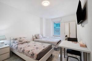a small bedroom with a bed and a desk and a table at Haus Rosa in Albstadt