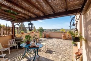 a patio with a table and chairs and a view at Casa Bice in Marcialla