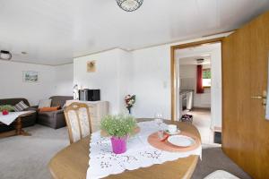 a living room with a dining table and a living room at An der Rehkoppel in Boren