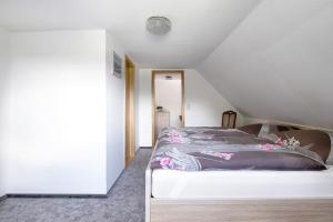 a bedroom with a bed in a attic at An der Rehkoppel in Boren