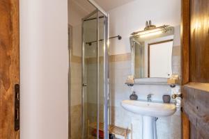 a bathroom with a sink and a glass shower at Gea - In Parulia Country House in Arezzo +31 photos