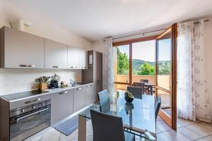 a kitchen and dining room with a glass table at Kastel's house in Roe
