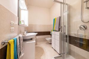 a bathroom with a sink and a toilet and a shower at Kastel's house in Roe +12 photos