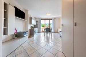 a kitchen with a large tile floor and white cabinets at Kastel's house in Roe