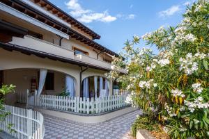 a house with a white fence and trees at Kastel's house in Roe