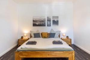 a bedroom with a large bed with two night stands at Ferienhaus Optikstadt Rathenow in Rathenow