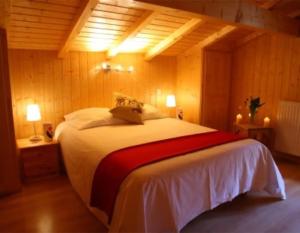 a bedroom with a large bed in a room at Chalet Myrtille in Morzine