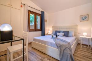 a bedroom with a bed and a desk and a television at Villa Aloe in Costa Paradiso