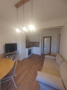 a living room with a couch and a table at Civico 316 con Piscina in Porto Recanati