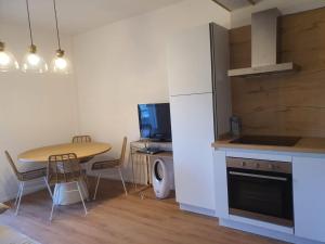 a kitchen with a table and a small table and chairs at Civico 316 con Piscina in Porto Recanati