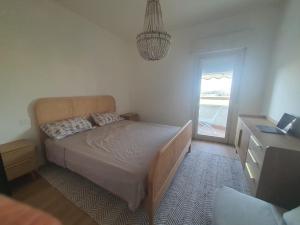 a bedroom with a bed and a dresser and a window at Civico 316 con Piscina in Porto Recanati +22 photos