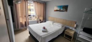 a small bedroom with a bed with a tray on it at Hospedaje costa pacífico in Chimbote