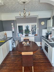 a kitchen with a table in the middle of it at Moon River in Goodwick