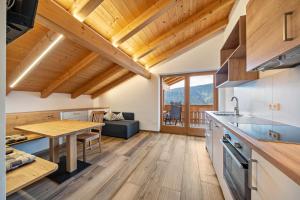 a kitchen and living room with a table and a dining room at Matscherhof Ferienwohnung Helena in Santa Valpurga