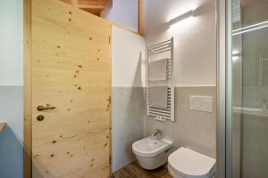 a bathroom with a toilet and a sink and a shower at Matscherhof Ferienwohnung Helena in Santa Valpurga +5 photos