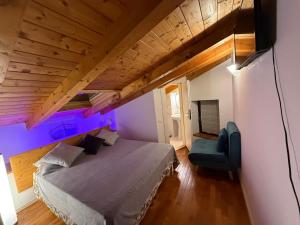 a bedroom with a bed with purple lighting at Alle Rive apartment in Salò