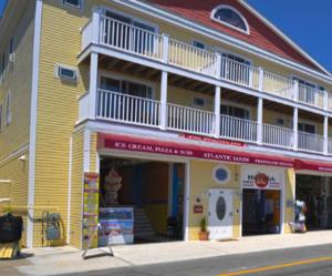 a yellow and white building on the side of a street at Atlantic Sands in Hampton