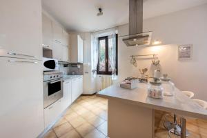 a kitchen with white cabinets and a counter top at Alle Rive apartment in Salò
