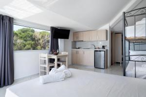 a large white kitchen with a large window in a room at Iguana studio 18 in Preveza