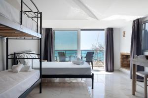 a bedroom with two bunk beds and a balcony at Iguana studio 18 in Preveza +20 photos