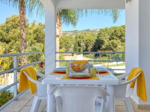a white table and chairs on a balcony with a view at Fustera in Benissa