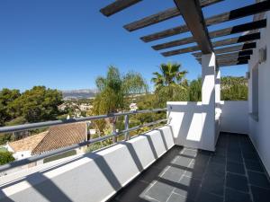 a balcony with white chairs and a view at Fustera in Benissa