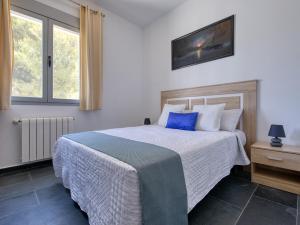 a bedroom with a bed with a blue pillow at Fustera in Benissa +32 photos