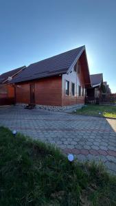 a house with a brick driveway in front of it at Figa Retreat in Beclean