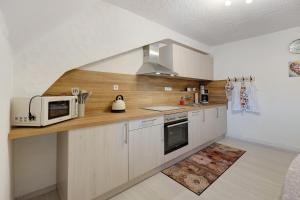 a kitchen with a microwave oven and a counter top at La Fleur in Tengen