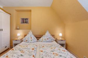 a bedroom with a bed with two lamps on two tables at La Fleur in Tengen