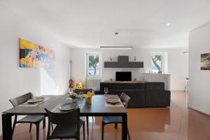 a living room with a table and chairs and a couch at Domaso front lake in Domaso