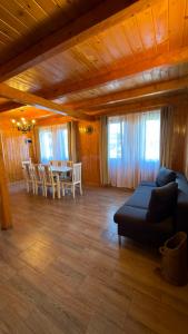 a living room with a couch and a table at Figa Retreat in Beclean +19 photos