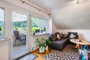 a living room with a couch and a table at Ferienwohnung Haus Waldfee in Sulzburg