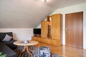 a living room with a couch and a table at Ferienwohnung Haus Waldfee in Sulzburg
