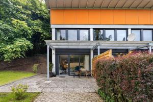 an orange house with a patio in front of it at Apartment am Wald in Dörentrup