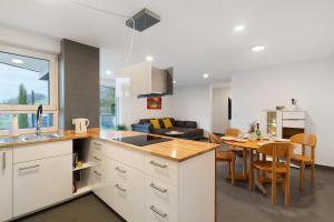 a kitchen and living room with a table and a couch at Relax Oase in Sasbachwalden