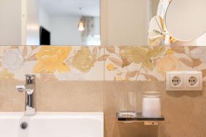 a bathroom with a sink and a mirror at Haus Rosengarten Apt B in Terlano +22 photos